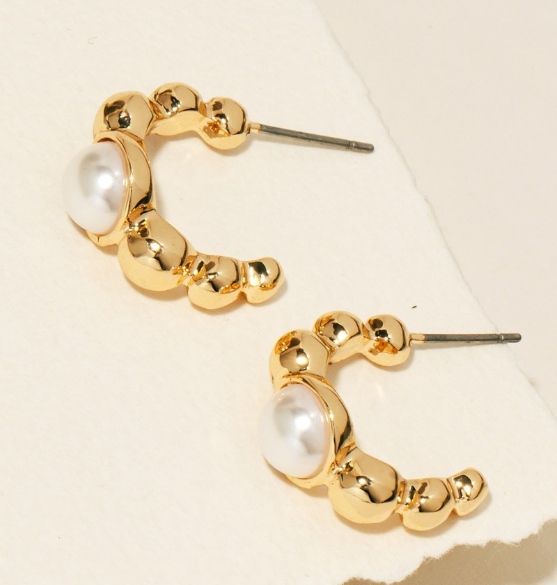 Gold-tone mini hoop earrings with a pearl accent on white background