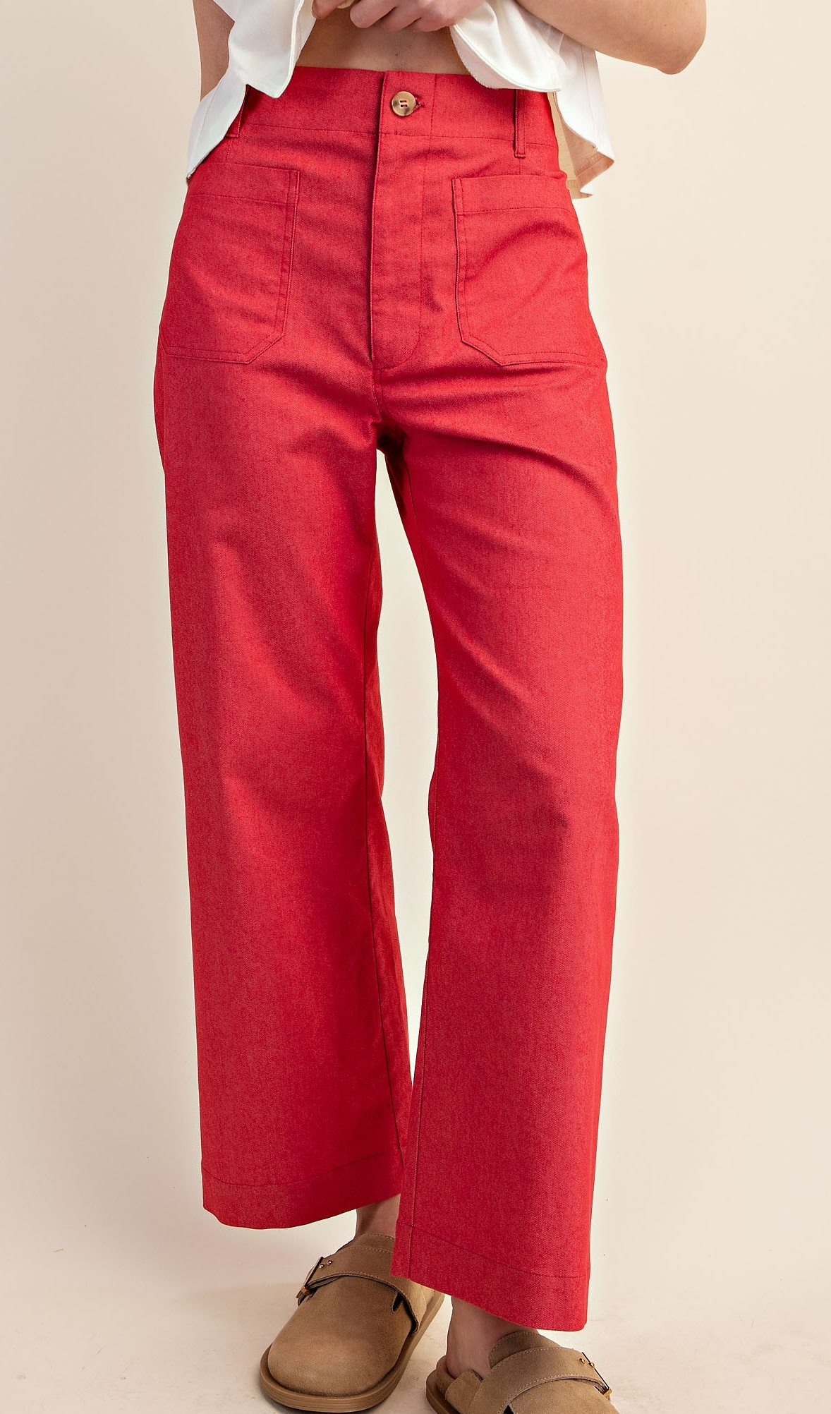 Woman wearing raspberry pink cropped high-rise utility pants with wide-leg fit and front pockets.