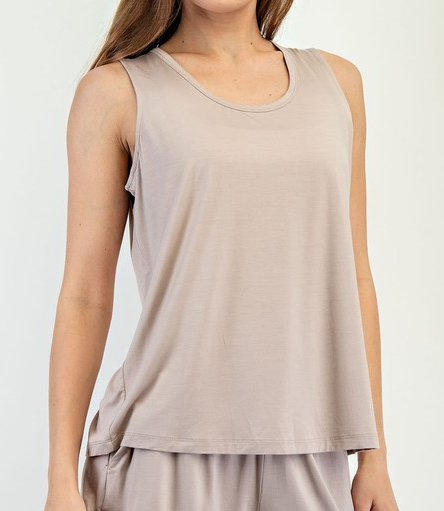 Model wearing a taupe sleeveless viscose modal tank top with a relaxed fit and scoop neckline.