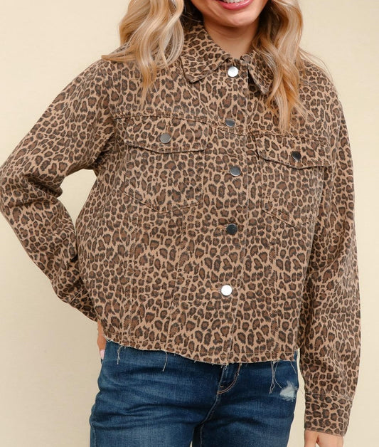 
Woman wearing washed leopard print jacket with button front, chest pockets, and raw hem detail.