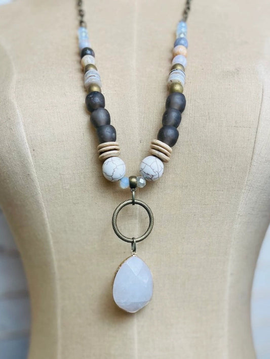 seaglass necklace with quartz pendant, howlite, agate, and matte gold beads on mannequin