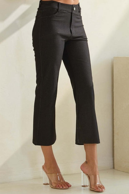 Black high-rise cropped kick flare pants styled with clear heels. Made from a cotton-blend stretch fabric. Available in sizes S-3X.