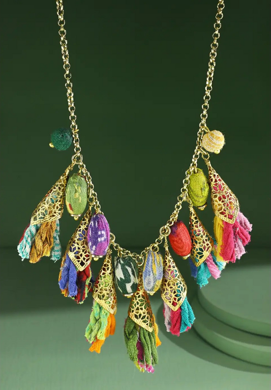 Multi tassel boho necklace with gold cones and colorful fabric bead accents on gold chain