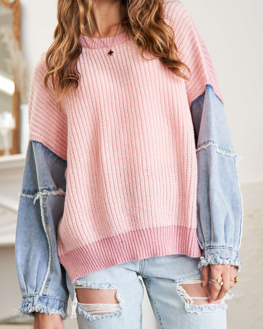 Pink knit sweater with frayed denim sleeves and ribbed hem.