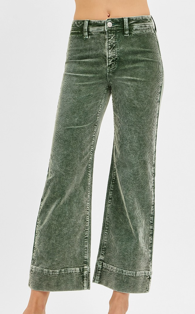 Forest green corduroy pants with straight leg, high rise, and wide hem detail.
