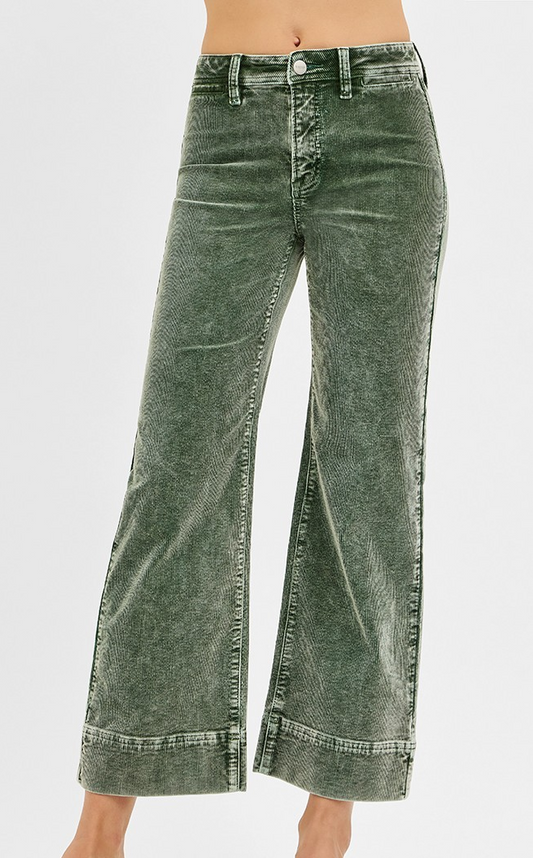 Forest green corduroy pants with straight leg, high rise, and wide hem detail.