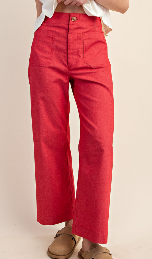 Woman wearing raspberry pink cropped high-rise utility pants with wide-leg fit and front pockets.