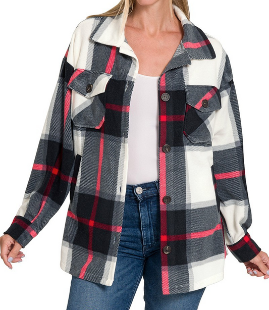Plaid fleece shacket with button front and chest pockets, worn open over a white top and jeans.