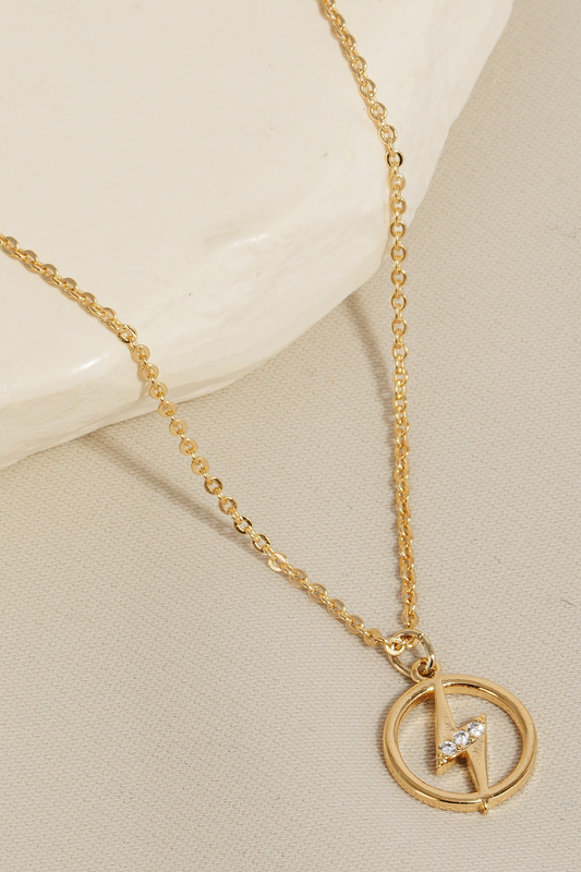 Gold lightning bolt pendant necklace with rhinestone accents on a delicate chain, shown on neutral background.