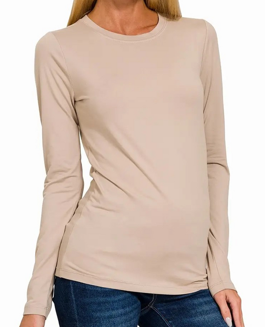Woman wearing light mocha brushed microfiber crew neck long sleeve tee with slim fit and lightweight stretch fabric.