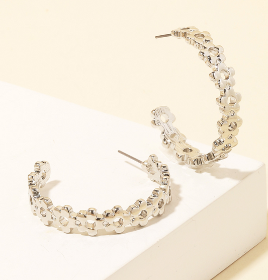 Silver flower cutout hoop earrings with post back on white background